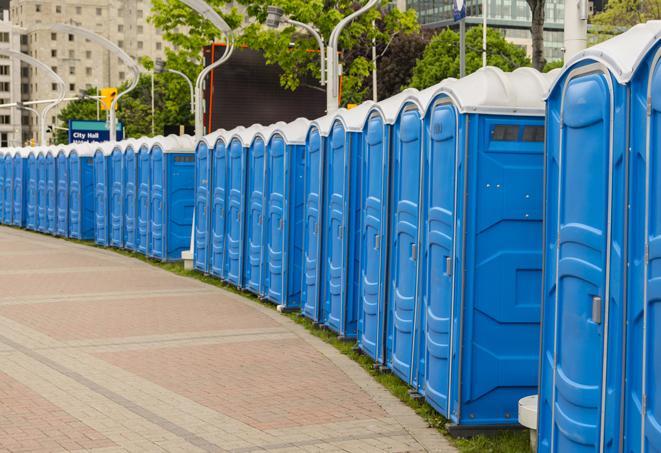 a row of portable restrooms set up for a large athletic event, allowing participants and spectators to easily take care of their needs in Alexander AR